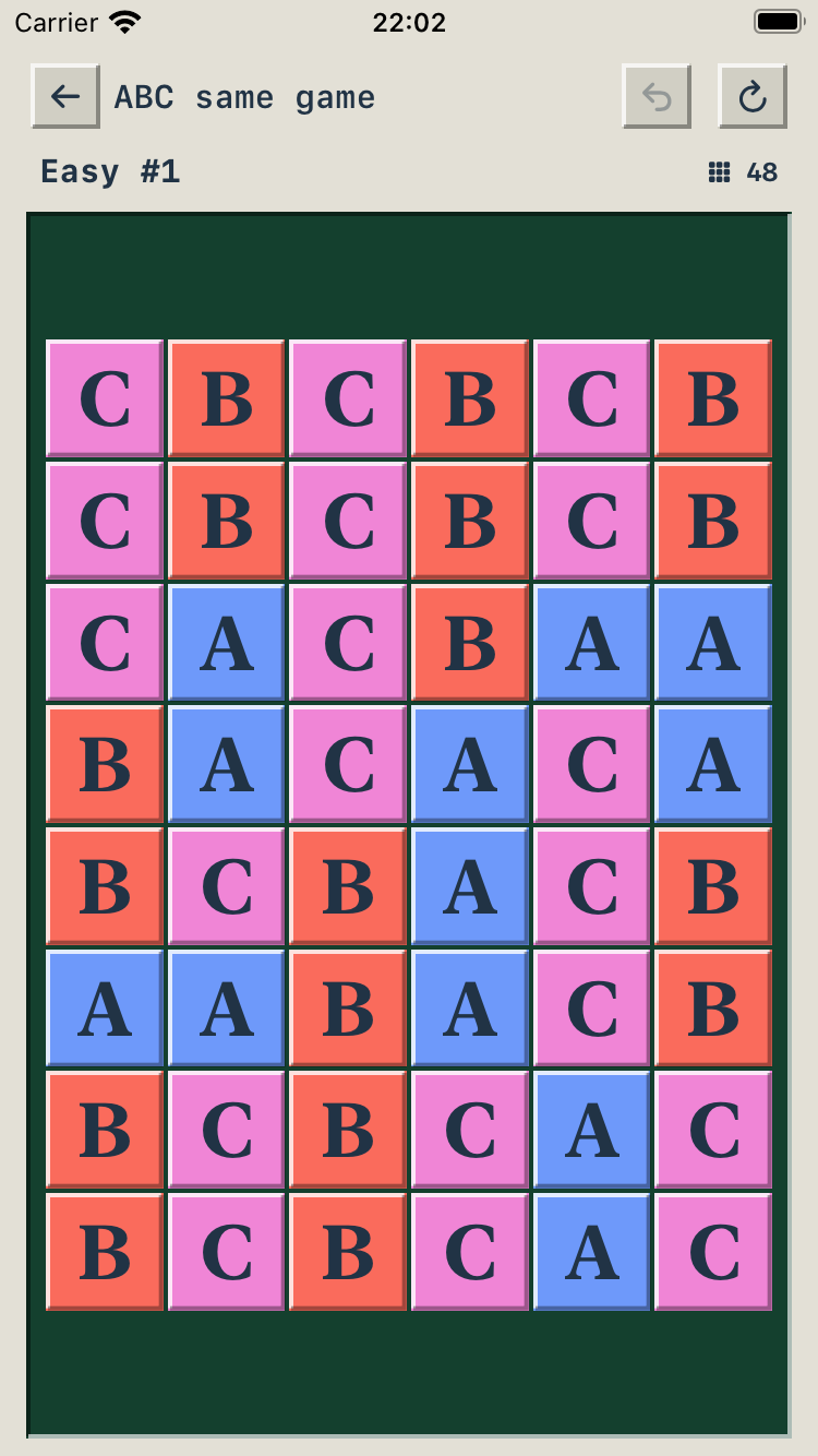 Actual iPhone gameplay: Easy level 1, with blue A, red B and pink C tiles on a green board.